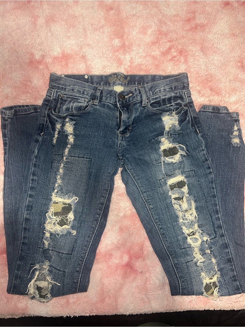 Distressed jeans with camo print